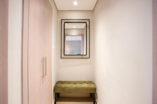 a small hallway with a bench and a mirror at Ferrari World & Seaworld - Luxe 2bhk Canal View in Yas Island