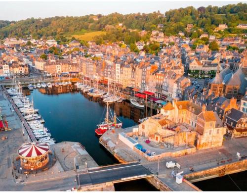 an aerial view of a harbor with boats in the water at Studio du Mesnil in Équemauville