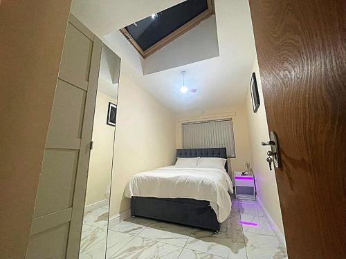 a bedroom with a bed and a skylight at Modern Flat near StarCity, Bull Ring & M6 in Birmingham