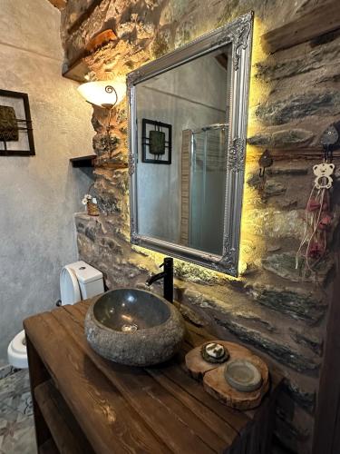 a bathroom with a stone sink and a mirror at Luxury Suites in Villa Anasia, Amaryllis in Skotina