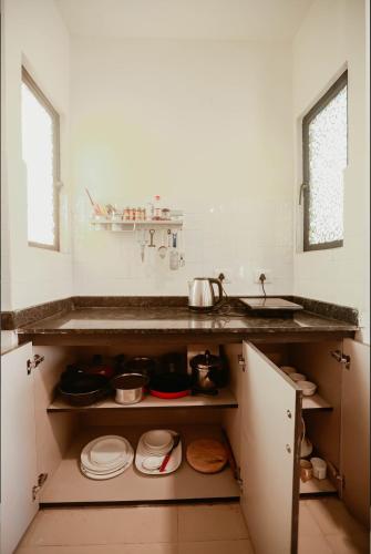 a kitchen with a sink and a counter top at Kudrats Vintage Loft - Sea & Island view Retreat in Canacona