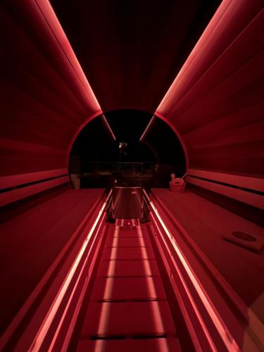 an escalator in a red tunnel with red lights at Matteo Villa Limassol Cyprus in Limassol