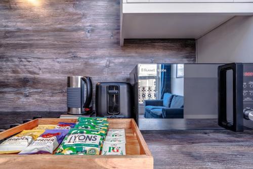 a counter with bags of chips on a table at Artful flat with skyline view, Stokes Croft in Bristol