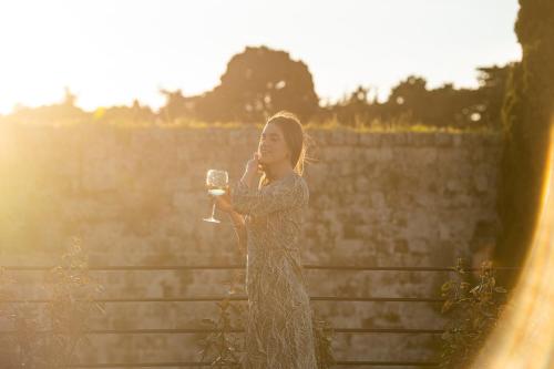 a young woman holding a glass of wine at Fluvian Terrace in Rhodes Town