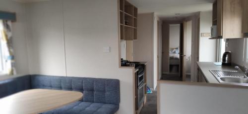 a blue couch in a kitchen next to a counter at Billing Aquadrome, Horizon 3 Bedrooms, BLP 17A in Northampton