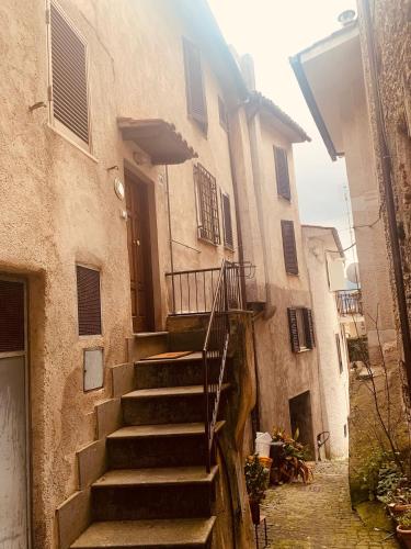 a set of stairs leading to a building with a door at La Casa di Vale in Marano Equo