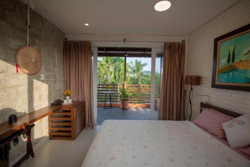 En eller flere senge i et værelse på Laoxao RiverStone Villa