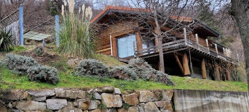 a house on top of a hill with a stone wall at Chalet fuste in Dornas