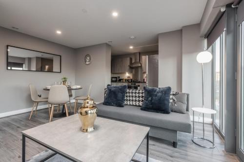 a living room with a couch and a table at Dockside Escape By Royal Albert Dock in Liverpool