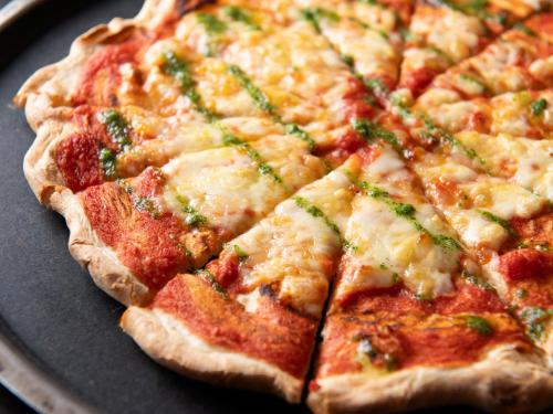 a pizza sitting on top of a pan at Mitsui Garden Hotel Shiodome Italia-gai - Tokyo in Tokyo