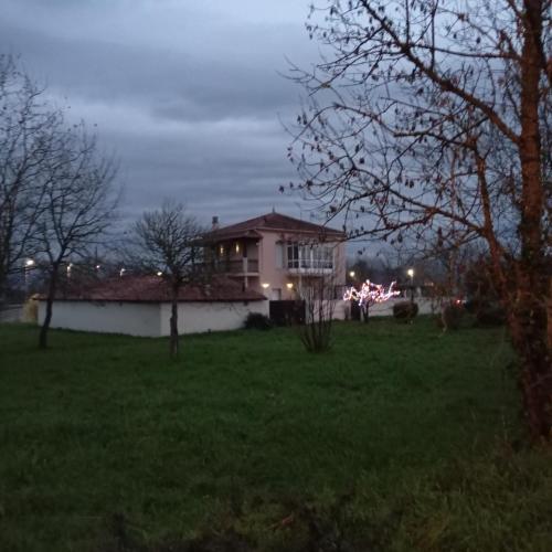 a house in a yard at night with lights at O toxal in Monforte de Lemos
