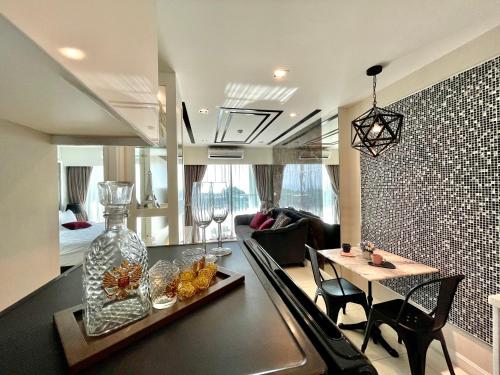 a living room with a table with a vase on it at Deamber Bangsare Pattaya in Bang Sare