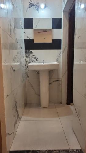a bathroom with a sink and a shower at Blue Waves Beach Resort in Vetāpālem