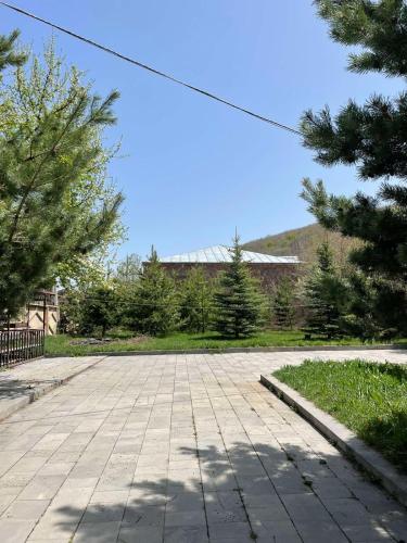 an empty parking lot with trees and a building at Dream House in Tsaghkadzor