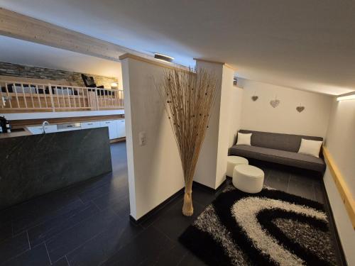 a living room with a couch and a vase at Leitingerhof in Virgen
