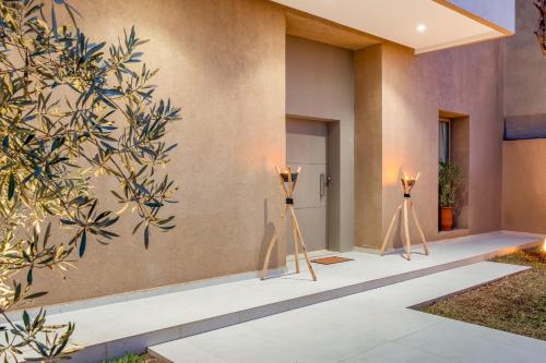 a facade of a house with two lights on posts at Villa Yas, Heated Pool, 15min from City Center, 4 Bedrooms, Private Cook and Airport Pickup in Marrakech