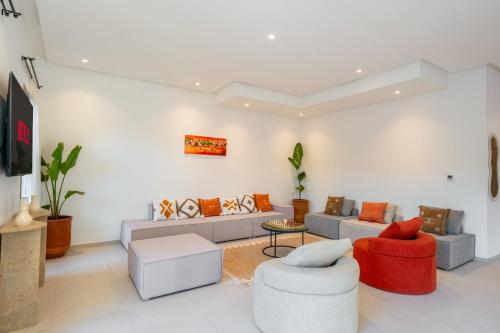 a living room with a couch and two chairs at Villa Yas, Heated Pool, 15min from City Center, 4 Bedrooms, Private Cook and Airport Pickup in Marrakech