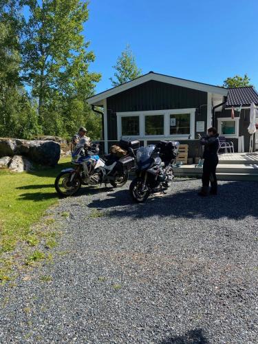 a couple of motorcycles parked in front of a house at Henar Bed & Breakfast in Gävle