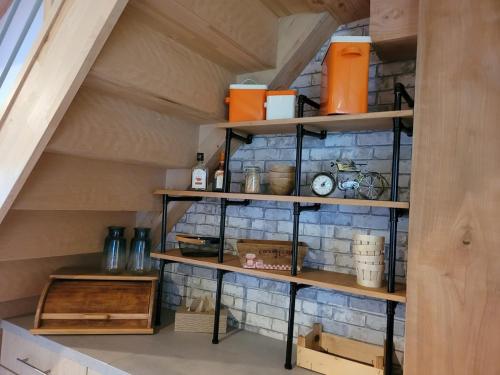 a staircase with wooden shelving in a room at Évasion en Normandie in La Patrie