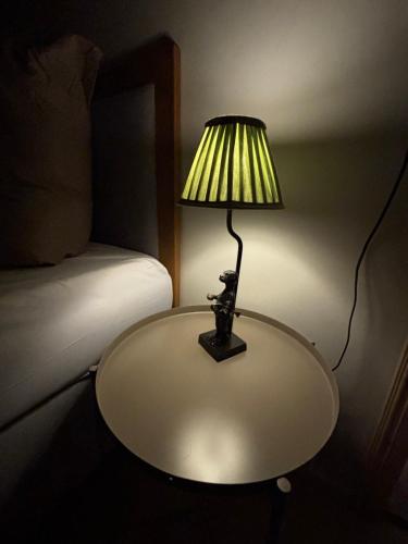 a lamp sitting on a table next to a bed at Haus Steiner #Mitten im Schwarzwald# in Lauterbach