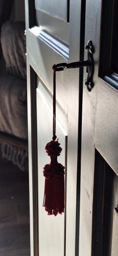 a door with a red object hanging from it at Agriturismo La Pina in Tarzo