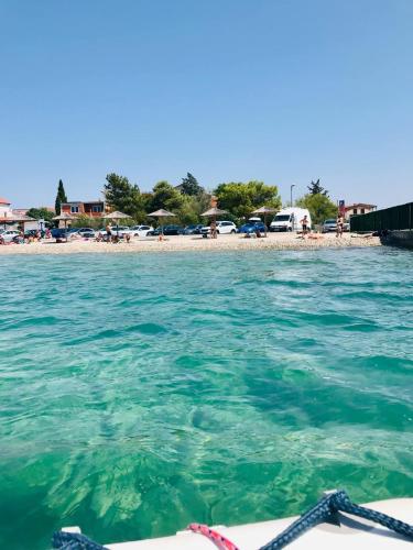 a view of a beach from a boat in the water at Apartman AS in Pirovac