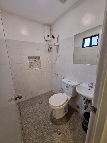 a bathroom with a toilet and a sink at Flat 35, Unit 3C in Manila