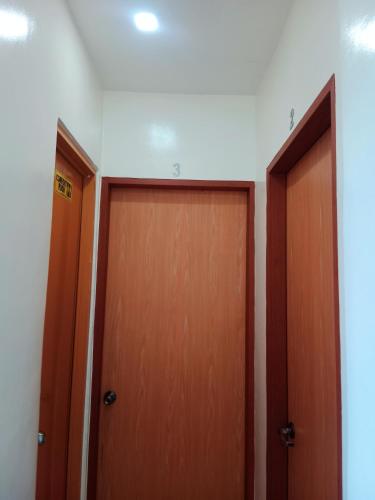 two wooden doors in a room at DJL Summer House - Bantayan Island in Patao