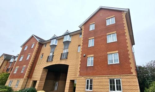 a large brick building with a tunnel in it at Riverview Apartments by Switchback Stays in Cardiff