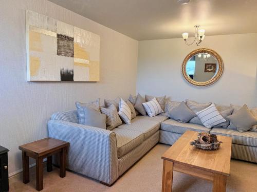 a living room with a couch and a table at Standlow Farm in Kniveton