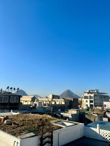 a view of a city with buildings and mountains at Hotel White House - A Family Homestay in Pushkar