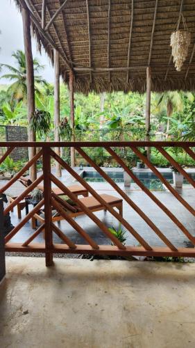 a wooden frame of a porch with a table at Boho villas and spa in El Valle