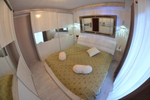 a small room with a bed with two white pillows at Apartment Beg in Rab