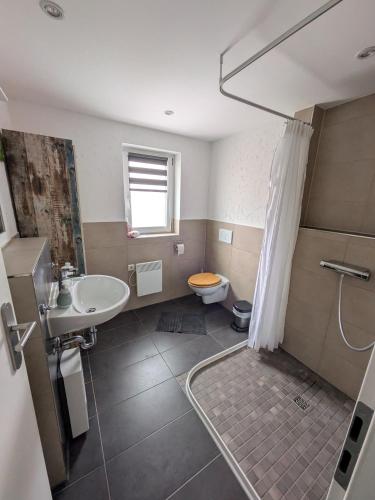 a bathroom with a sink and a toilet at fewoflagmeier Meidelstetten I Maisonetten Wohnung Alb in Hohenstein
