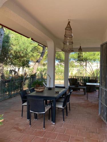 a patio with a table and chairs on a porch at Villa Del Prete in Sant'Isidoro