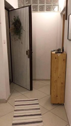 a room with a door and a rug next to a gate at Haus Ljubica Ražanac in Ražanac
