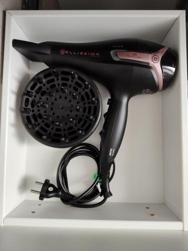 a hair dryer and a hair brush in a drawer at Civico 34 Urban House in Ciampino