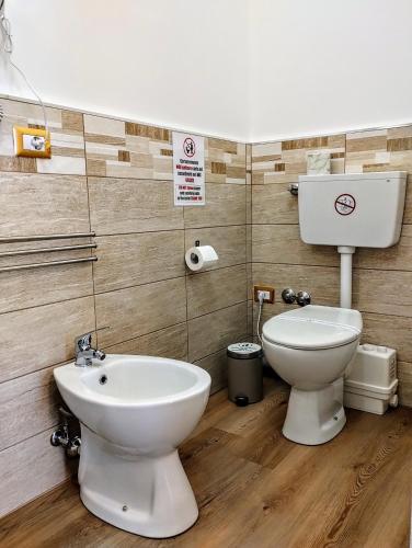 a bathroom with a toilet and a sink at Suleima B&B Messina Centro in Messina