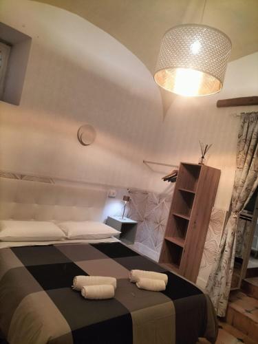 a bedroom with a bed with two towels on it at Siconolfo 5 in Salerno