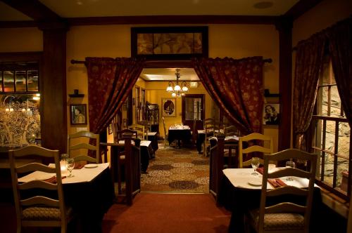 a restaurant with tables and chairs in a room at Glen Tavern Inn in Santa Paula