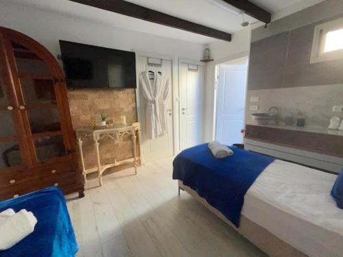a bedroom with a large bed and a bathroom at Ahuzat Shaul Seaside in H̱adera