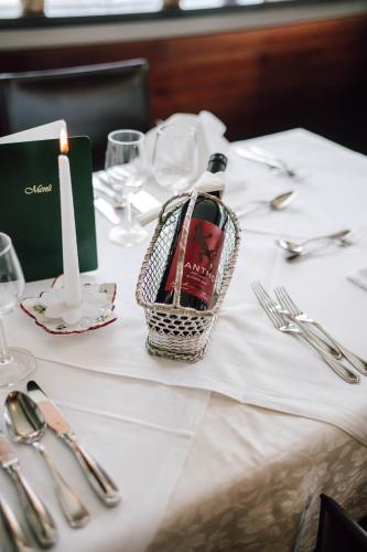 a table with a candle and a basket of wine on it at Hotel Montjola Nova in Schruns-Tschagguns