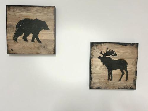 two pictures of a bear and a deer on a wall at Ahuzat Shaul Seaside in H̱adera