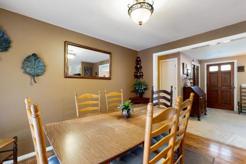 a dining room with a wooden table and chairs at Welcome Home in North Conway