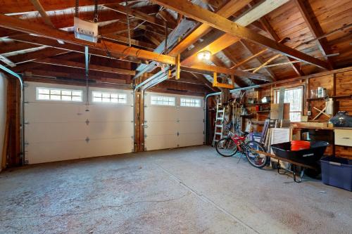 a garage with two white garage doors in a building at Welcome Home in North Conway