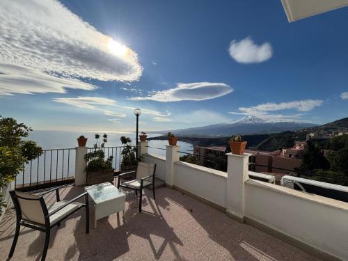 a balcony with a table and chairs and a view at Hotel Elios Tao in Taormina