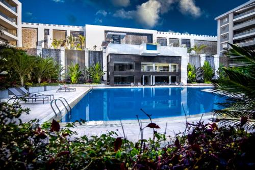 a large swimming pool in front of a building at The Expert in Ocean Blue Near Airport in Cairo