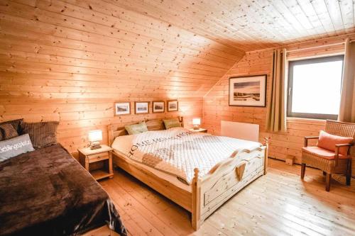 a bedroom with a bed in a wooden cabin at Schmuckstück in Hasselfelde