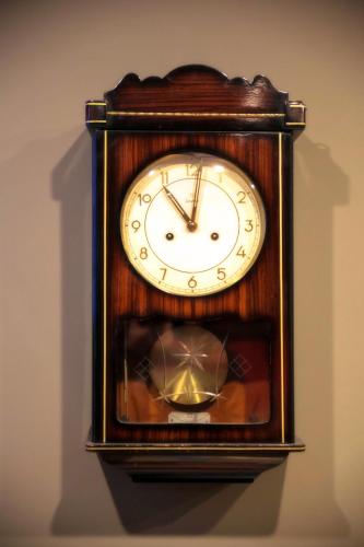 a wooden clock hanging on a wall at Akin Suites in Istanbul