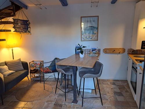 kuchnia i salon ze stołem i krzesłami w obiekcie La Trémière, maison de village, sauna, vue garrigue w mieście Bouzigues